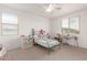 Bright bedroom with a ceiling fan and sunny windows at 16789 W Moreland St, Goodyear, AZ 85338