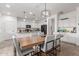 Dining area featuring a modern chandelier, neutral decor, and an open-concept layout with the kitchen at 16789 W Moreland St, Goodyear, AZ 85338