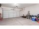 Spacious two car garage with lots of storage space and a door to the outside at 16789 W Moreland St, Goodyear, AZ 85338