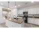 Bright kitchen features granite counters, stainless steel appliances, and modern pendant lighting at 16789 W Moreland St, Goodyear, AZ 85338