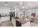 Open concept kitchen featuring granite counters, stainless steel appliances, and a breakfast bar at 16789 W Moreland St, Goodyear, AZ 85338