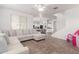 Open concept living room with neutral walls, tile flooring, recessed lighting and a sofa at 16789 W Moreland St, Goodyear, AZ 85338