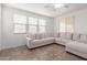 Cozy living room features neutral walls, tile flooring, recessed lighting and a sofa at 16789 W Moreland St, Goodyear, AZ 85338