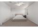 Relaxing bedroom features a ceiling fan, neutral decor, and comfortable carpet flooring at 16789 W Moreland St, Goodyear, AZ 85338