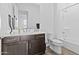 Bathroom featuring a shower-tub combo with a large vanity and sleek fixtures at 17205 W Middlebury St, Surprise, AZ 85388