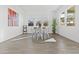 Light-filled dining area with modern table, chairs, an abstract art piece, and tile flooring at 17205 W Middlebury St, Surprise, AZ 85388