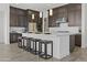 Gorgeous kitchen island with dark cabinetry, white countertops, and seating for four at 17205 W Middlebury St, Surprise, AZ 85388