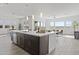 Spacious kitchen island with barstool seating, undermount sink, and stainless steel dishwasher at 17205 W Middlebury St, Surprise, AZ 85388