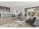 Bright, open-concept living room flowing into the kitchen with sleek furniture and tile flooring at 17205 W Middlebury St, Surprise, AZ 85388