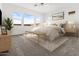 Stylish main bedroom features neutral carpet, a large bed, and bright light at 17205 W Middlebury St, Surprise, AZ 85388