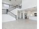 View of modern staircase, kitchen with island, stainless steel appliances, tile flooring, and open space at 17745 W Carol Ave, Waddell, AZ 85355