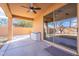 Relaxing back patio with ceiling fan, offering shade and views of the backyard, perfect for outdoor living and entertaining at 18430 E Ashridge Dr, Queen Creek, AZ 85142