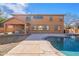 Spacious backyard with pool, covered patio, and grass at 18430 E Ashridge Dr, Queen Creek, AZ 85142