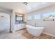 Modern bathroom with standalone tub, decorative wall, and a countertop with a vessel sink at 18430 E Ashridge Dr, Queen Creek, AZ 85142