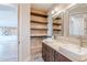 Modern bathroom with double sinks, quartz countertops, and custom shelving at 18430 E Ashridge Dr, Queen Creek, AZ 85142