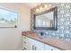 Modern bathroom with an elegant countertop and sink with a decorative wall and a single window for light at 18430 E Ashridge Dr, Queen Creek, AZ 85142