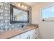 Modern bathroom with elegant countertop, contemporary mirror, and a decorative backsplash at 18430 E Ashridge Dr, Queen Creek, AZ 85142