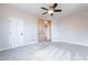 Spacious bedroom with plush carpeting, ceiling fan, and neutral color palette at 18430 E Ashridge Dr, Queen Creek, AZ 85142