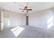 A bright bedroom features a large closet, soft carpeting, neutral walls, and a modern ceiling fan at 18430 E Ashridge Dr, Queen Creek, AZ 85142