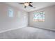 Bright bedroom with plush carpeting, ceiling fan, and natural lighting at 18430 E Ashridge Dr, Queen Creek, AZ 85142