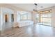 A bright dining room with hard wood floors, stylish lighting and large windows to the outside at 18430 E Ashridge Dr, Queen Creek, AZ 85142