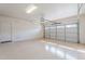 A spacious garage with clean epoxy floors and an automatic door at 18430 E Ashridge Dr, Queen Creek, AZ 85142