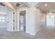 Hallway with plush carpet leads to rooms with bright neutral walls and large windows at 18430 E Ashridge Dr, Queen Creek, AZ 85142