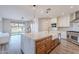 Open kitchen layout featuring a large island, stainless steel appliances, and hardwood floors at 18430 E Ashridge Dr, Queen Creek, AZ 85142