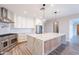 Spacious kitchen featuring a large marble island, stainless steel appliances and custom cabinets at 18430 E Ashridge Dr, Queen Creek, AZ 85142