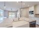 Modern kitchen featuring a large island with white farmhouse sink and access to the backyard at 18430 E Ashridge Dr, Queen Creek, AZ 85142