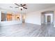 Bright living room with wood-look flooring and views into the open kitchen at 18430 E Ashridge Dr, Queen Creek, AZ 85142