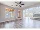 Bright and spacious living room with wood-look flooring and large windows at 18430 E Ashridge Dr, Queen Creek, AZ 85142