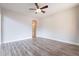 Open living room featuring wood-look flooring, a ceiling fan, and neutral paint at 18430 E Ashridge Dr, Queen Creek, AZ 85142