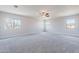 Spacious main bedroom with multiple windows and neutral carpet flooring at 18430 E Ashridge Dr, Queen Creek, AZ 85142