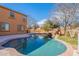 Backyard pool featuring a unique rock waterfall feature at 18430 E Ashridge Dr, Queen Creek, AZ 85142