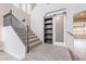 Carpeted staircase with decorative railing and a sliding barn door to additional storage at 18430 E Ashridge Dr, Queen Creek, AZ 85142