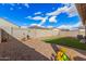 Spacious backyard with gravel, artificial grass, and desert-themed decor at 18434 W Chama Dr, Surprise, AZ 85387