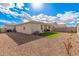 Gravel backyard with artificial turf and a covered patio area at 18434 W Chama Dr, Surprise, AZ 85387