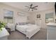 A bedroom features a white headboard, soft gray accents, and natural lighting at 18434 W Chama Dr, Surprise, AZ 85387