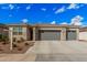 Charming home exterior with a stone facade, neutral color palette, and a spacious three-car garage at 18434 W Chama Dr, Surprise, AZ 85387