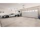 Spacious three car garage featuring a Corvette at 18434 W Chama Dr, Surprise, AZ 85387