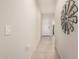 Hallway featuring light colored walls and tile floors leading to the front door at 18434 W Chama Dr, Surprise, AZ 85387