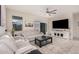 Bright living room featuring neutral furniture, tile floors, and a sliding door at 18434 W Chama Dr, Surprise, AZ 85387