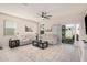 Bright living room featuring neutral furniture, tile floors, and a sliding door at 18434 W Chama Dr, Surprise, AZ 85387