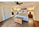 A well-lit main bedroom with a ceiling fan, wood-look flooring, and an en-suite bathroom at 18753 E Chinle Dr, Rio Verde, AZ 85263