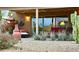 Cozy outdoor patio with a lounge chair, desert plants, and warm string lights at 18753 E Chinle Dr, Rio Verde, AZ 85263