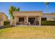 Spacious backyard with covered patio, outdoor seating, and lush green lawn perfect for leisure at 19093 N 97Th Ln, Peoria, AZ 85382