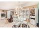 Bright dining area with glass table, white chairs, and views of the living room at 19093 N 97Th Ln, Peoria, AZ 85382