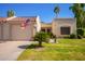 Charming home exterior with a well-manicured lawn, an American flag, and desert landscaping at 19093 N 97Th Ln, Peoria, AZ 85382