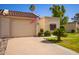 Charming home exterior with desert landscaping, a manicured lawn, and an American flag at 19093 N 97Th Ln, Peoria, AZ 85382